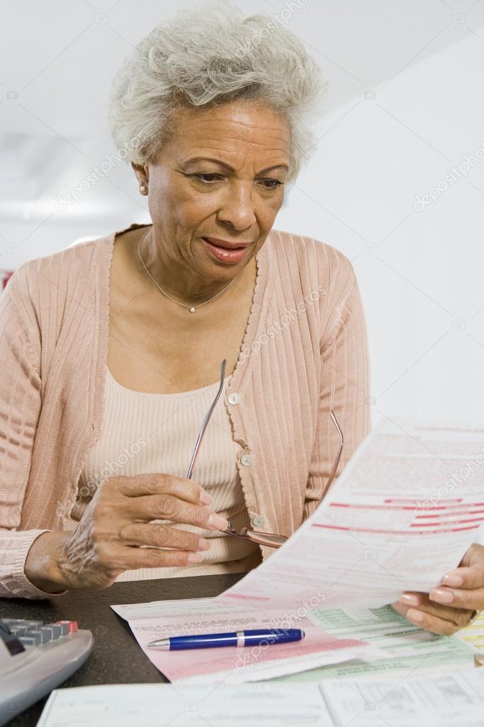 Senior Woman Reading Home Finances