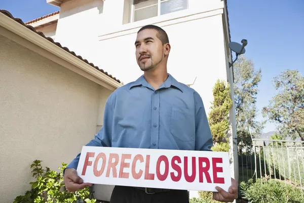 Man Holding "Foreclosure Sign" — Stock Photo, Image