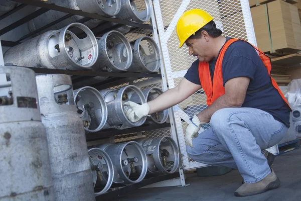 Worker checking the pressure of cylinder — Stock Photo, Image