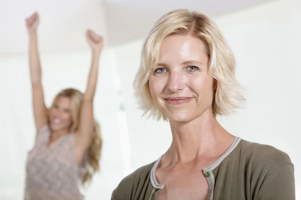 Close up of mother with excited daughter raising hands — Stock Photo, Image