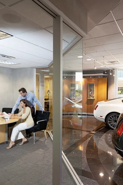 Woman signing contract of her new car — Stock Photo, Image