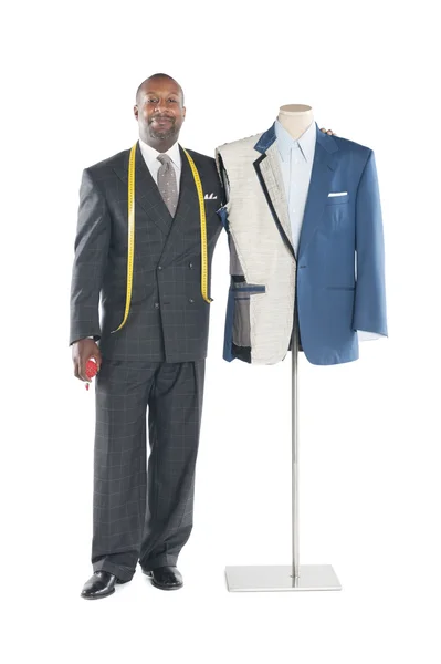 Portrait of a male tailor standing next to a mannequin — Stock Photo, Image