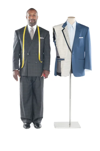 Portrait of tailor in formal wear standing besides a dummy — Stock Photo, Image