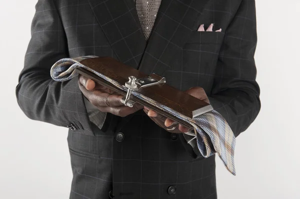 Midsection of man holding tie press — Stock Photo, Image