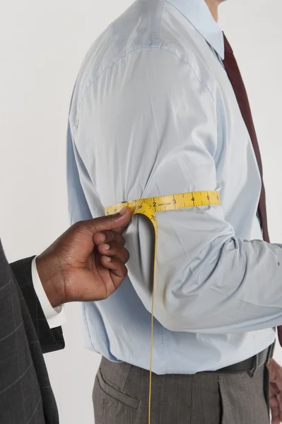 Tailor taking the measurement of a customer — Stock Photo, Image