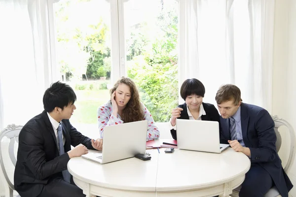Group of businesspeople working on laptop — Stock Photo, Image