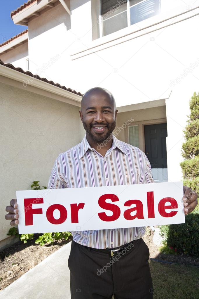 Real Estate Agent Holding 'For Sale' Sign