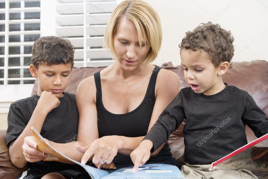 Mother reading book with two children