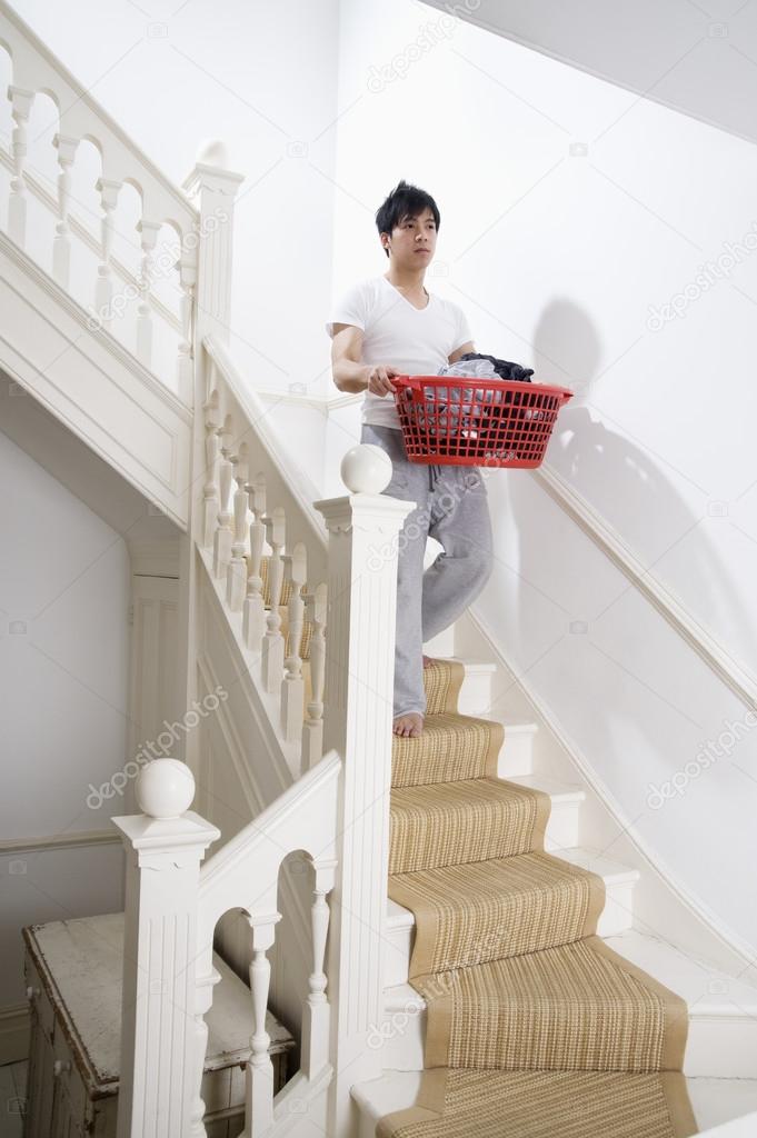 man carrying  laundry basket 