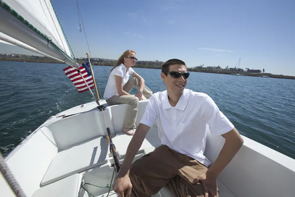 Couple Sailing In Sail Boat