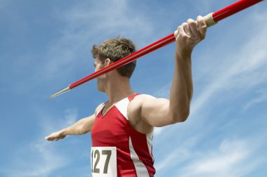 Male athlete about to throw javelin clipart