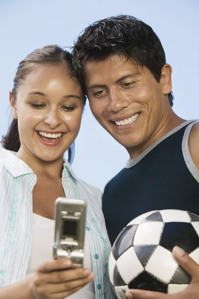 Couple using mobile phone — Stock Photo, Image