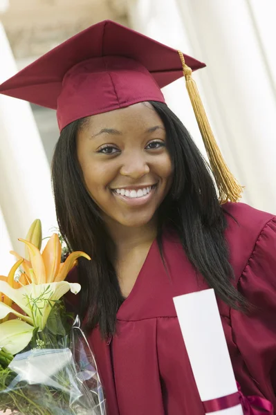 Graduate Holding Flowers and Diploma — Stock Photo, Image