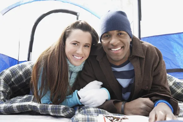 Couple lying in sleeping bags in the tent — Stock Photo, Image