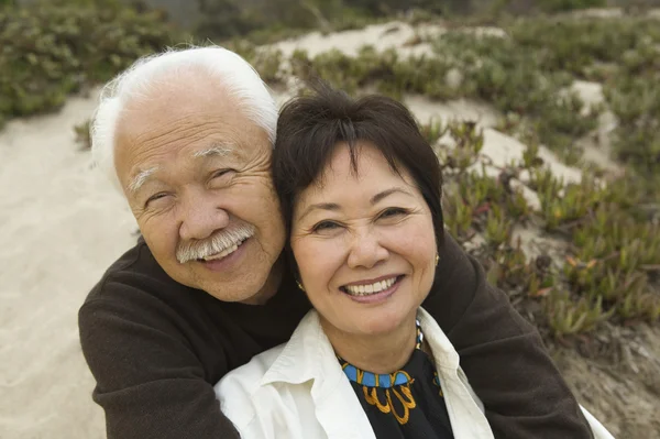 Mature Couple Sitting at Beach — Stock Photo, Image