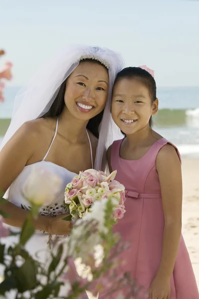 Bride and sister on beach — Stock Photo, Image