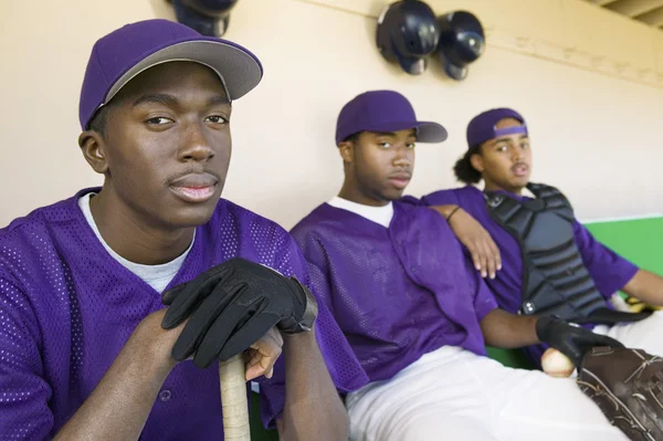 Players sitting in dugout — Stock Photo, Image