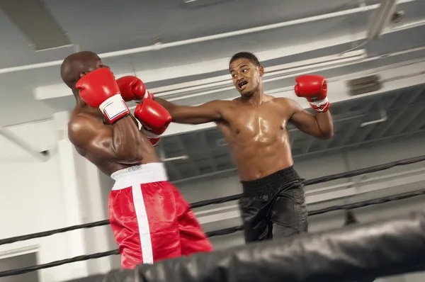 Boxers fighting in ring — Stock Photo, Image