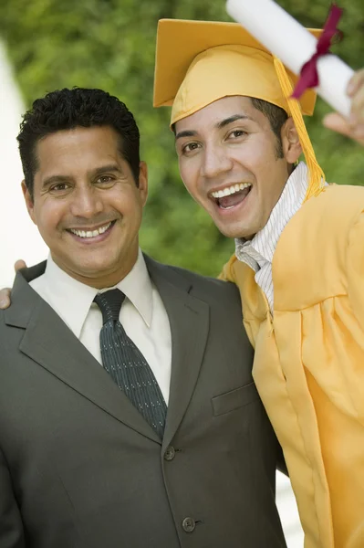 Graduate hoisting diploma — Stock Photo, Image