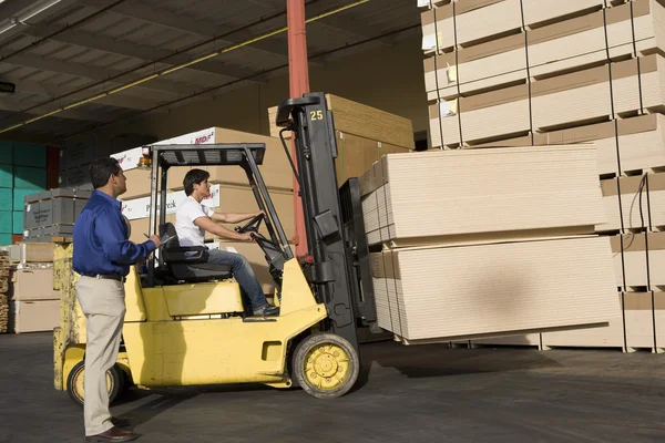 Warehouseman and forklift truck driver — Stock Photo, Image