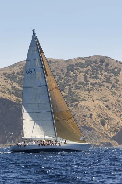 Sailboat near coast on ocean — Stock Photo, Image