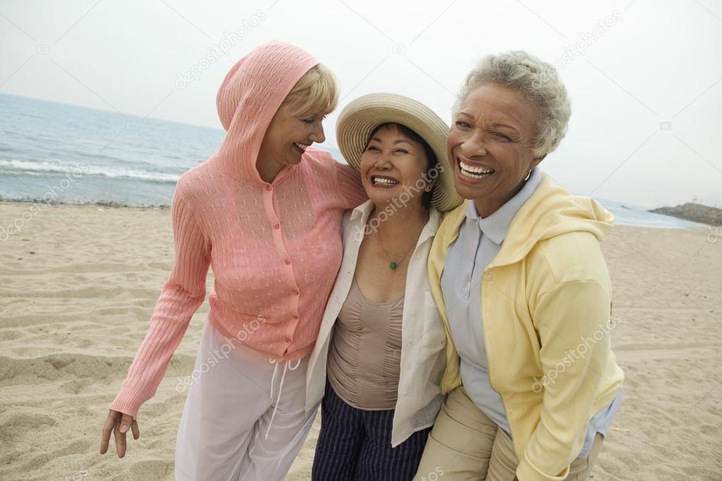 Female friends walking on beach