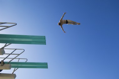 Man diving from diving board clipart