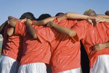 Soccer team in huddle clipart