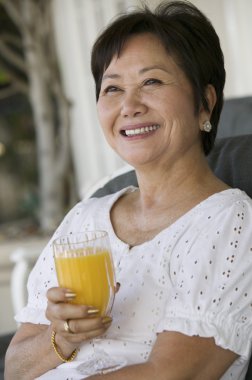 Woman drinking orange juice clipart