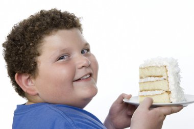 Overweight boy holding cake