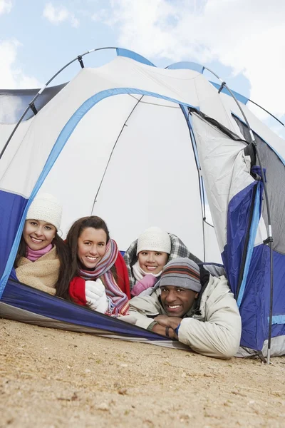 Friends lying in small tent — Stock Photo, Image