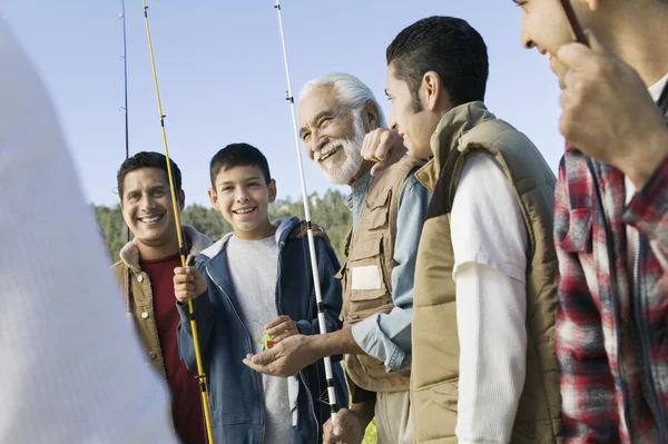 Family holding fishing rods — Stock Photo, Image