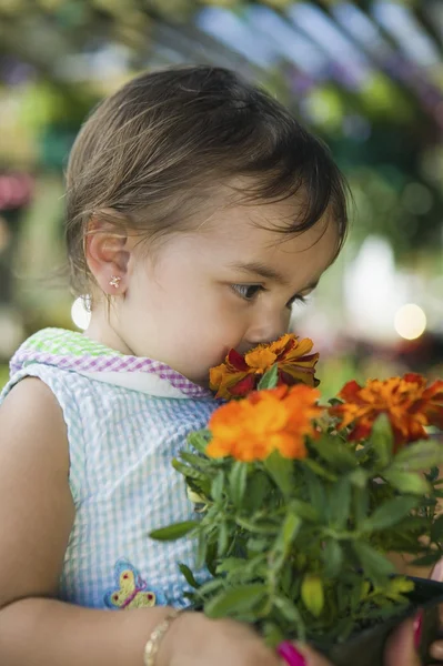 Girl Smelling Marigolds — Stock Photo, Image