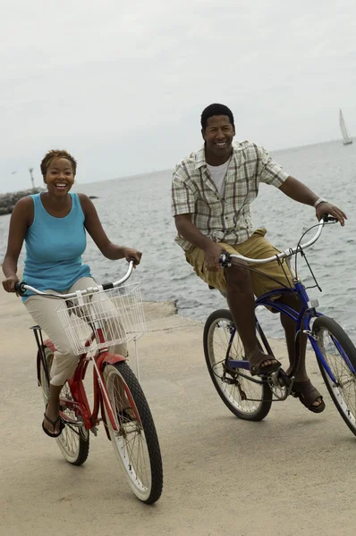 Couple cycling on beach