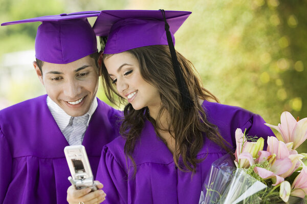 Graduates Using Cell Phone