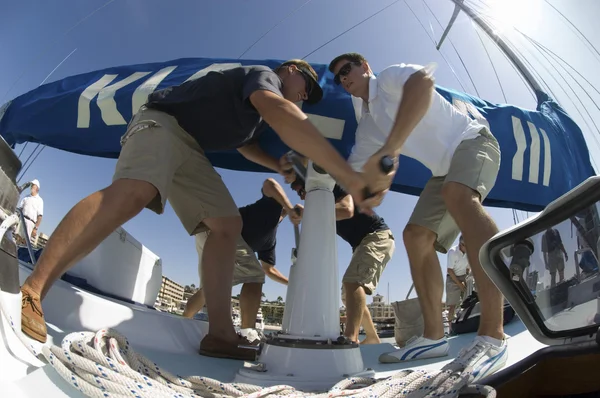 Sailors operating windlass on yacht — Stock Photo, Image