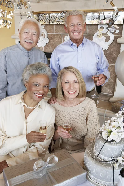 Friends with champagne in a party — Stock Photo, Image