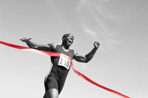 Runner crossing finish line — Stock Photo, Image