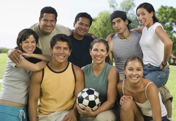 People in park holding soccer ball. — Stock Photo, Image