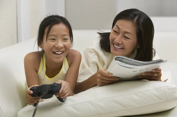 Mother reading, Daughter Playing — Stock Photo, Image