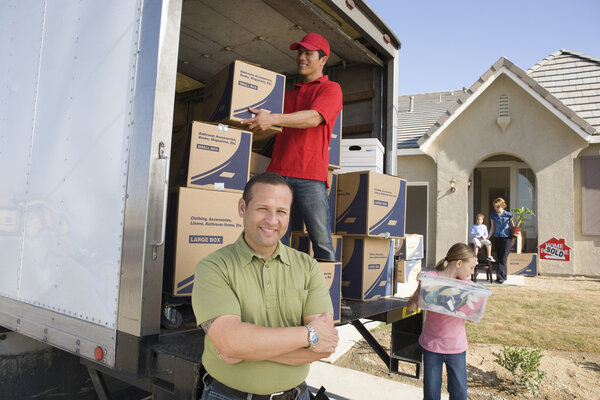 Family and worker unloading boxes