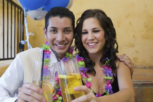 Couple toasting drinks outside school dance — Stock Photo, Image