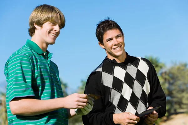 Golfers standing next to each other — Stock Photo, Image