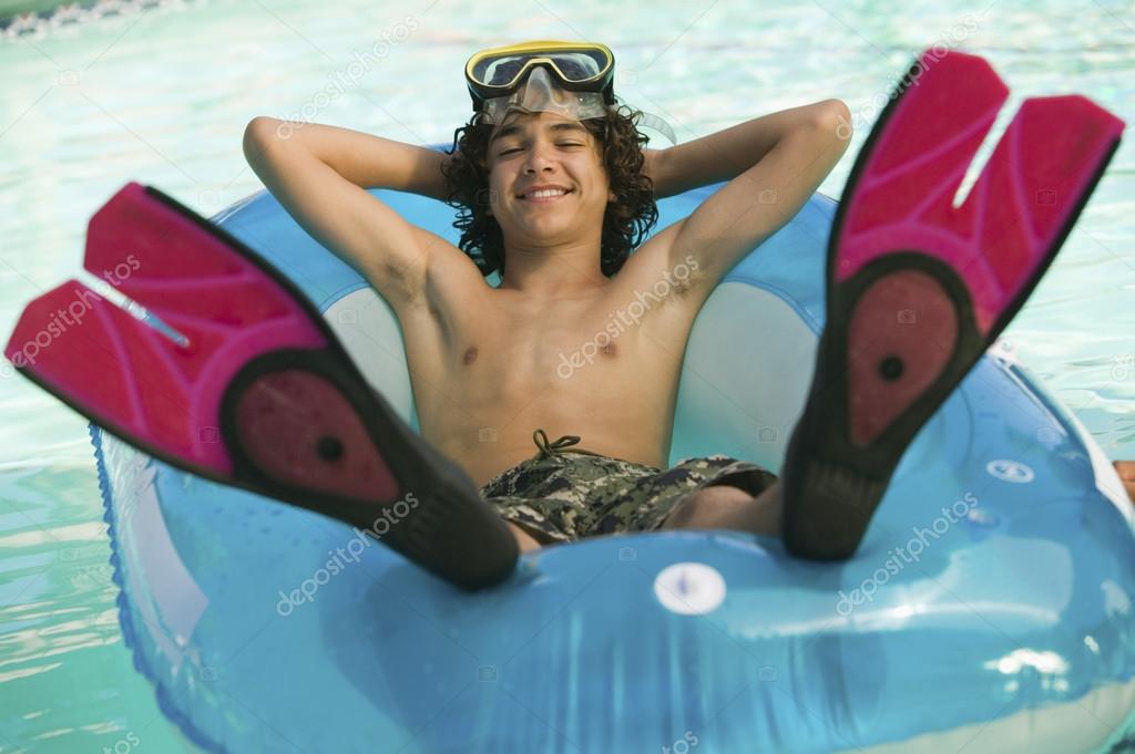 Teenager Relaxing in Swimming Pool