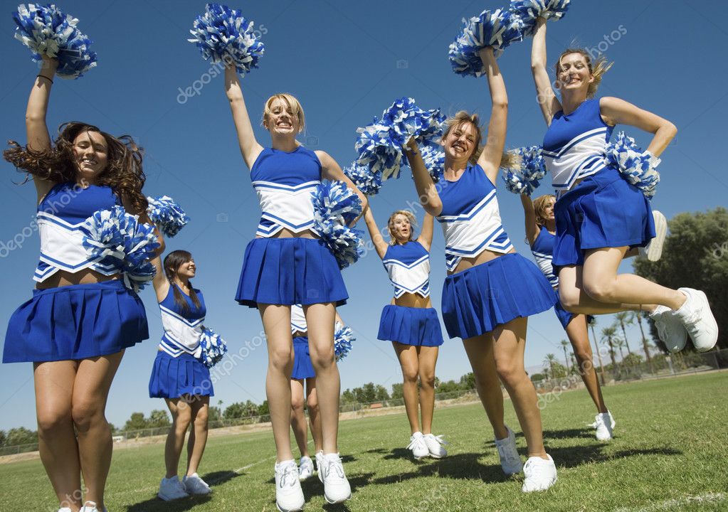 Cheerleaders rising pompoms — Stock Photo © londondeposit 33807927