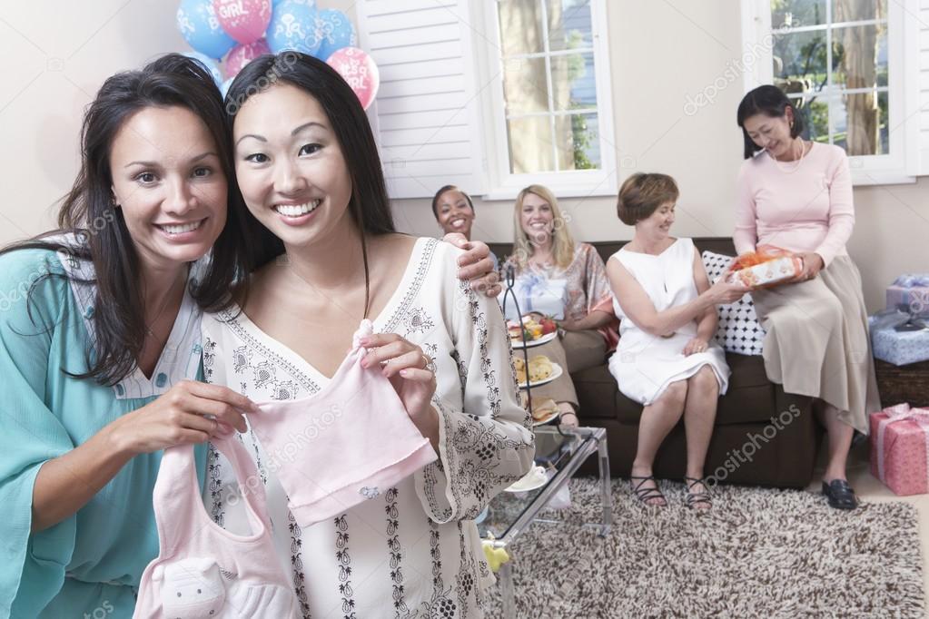 Woman with friend showing off gift