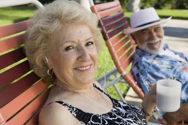 Senior Couple sitting on lawn chairs clipart