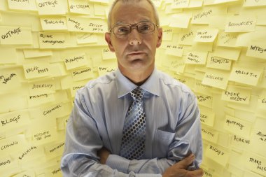 Businessman Standing at Wall with Post Its clipart