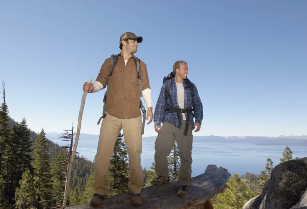 Hikers standing on log — Stock Photo, Image