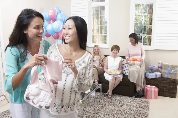 Woman showing gift at baby shower — Stock Photo, Image
